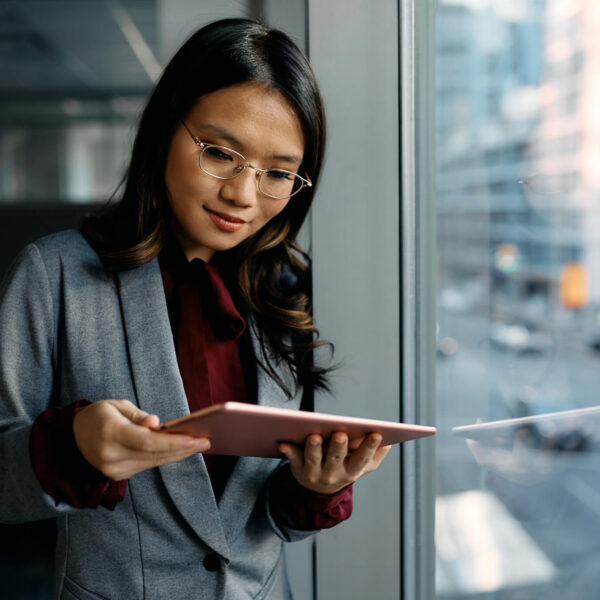 asian-female-executive-using-digital-tablet-by-the-window- asian-female-executive-using-digital-tablet-by-the-window-